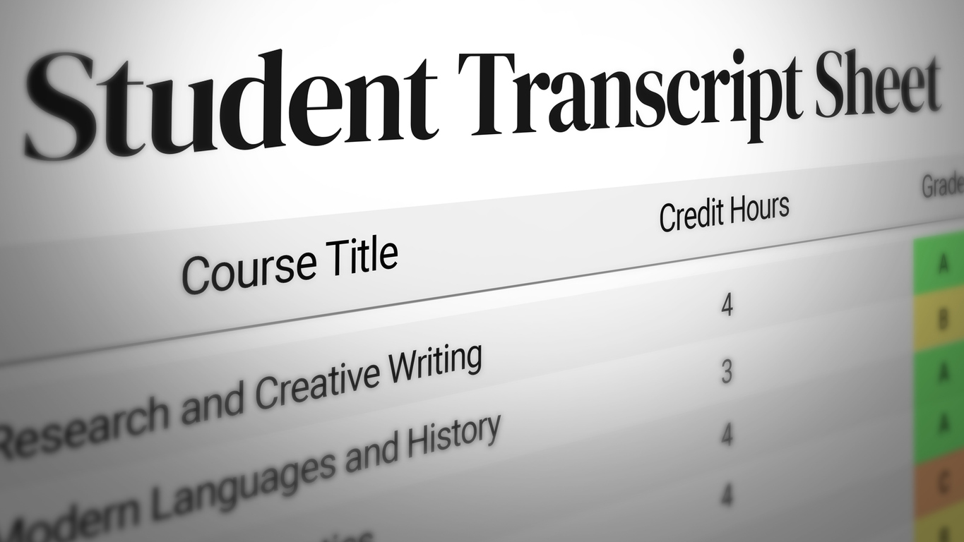 Adult learner reviewing prior high school transcripts and course documents beside a laptop.